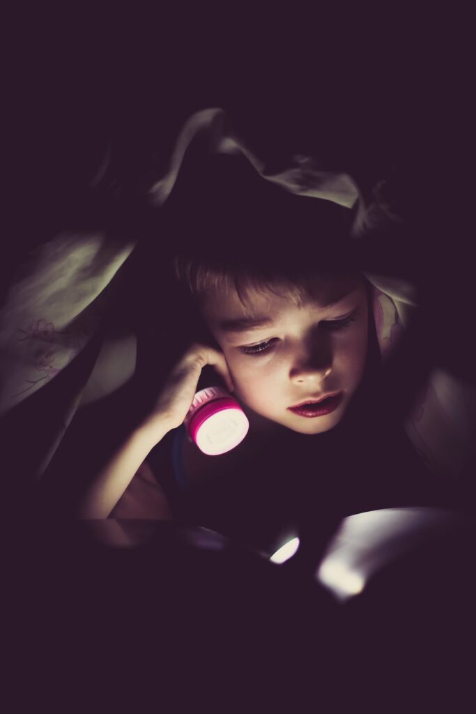 How to Help Your ADHD Child Sleep: Kid with flashlight